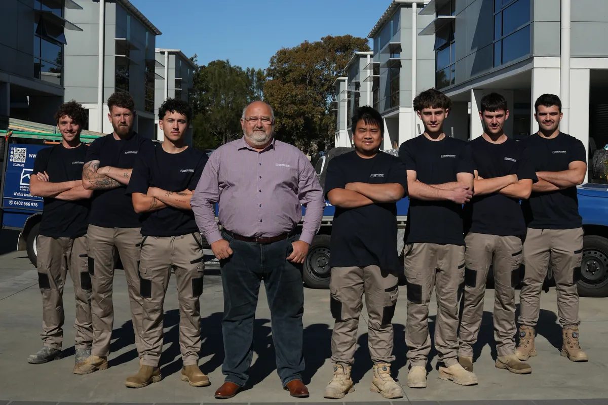 The South Coast Remedial Concrete Division team standing in front of their work ute in Wollongong NSW